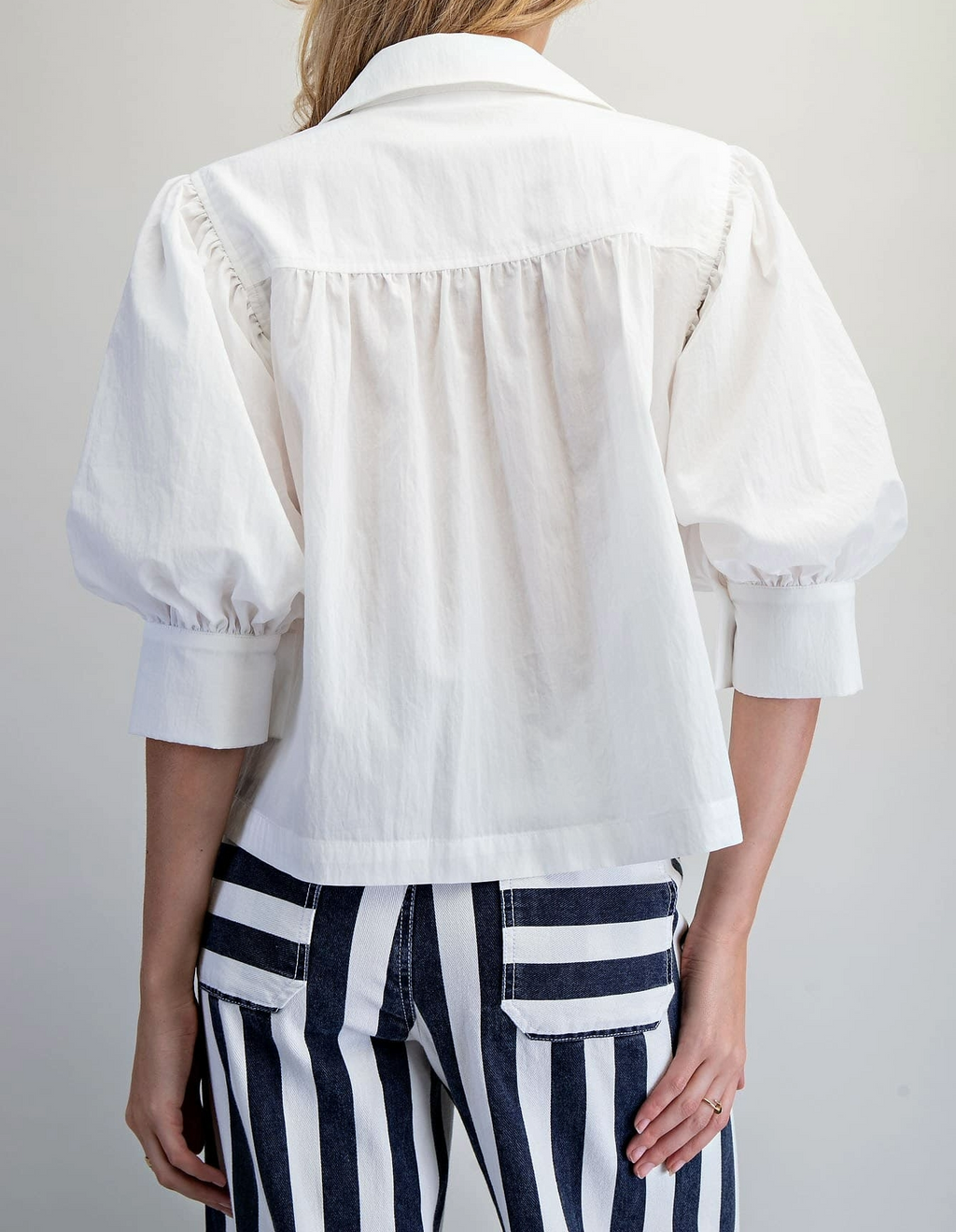 Off-white puff-sleeve button-down top, additional view showing sleeve and button detail