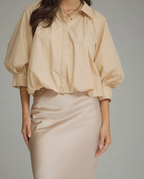 Ecru puff sleeve top with three-quarter puff sleeve and button cuff